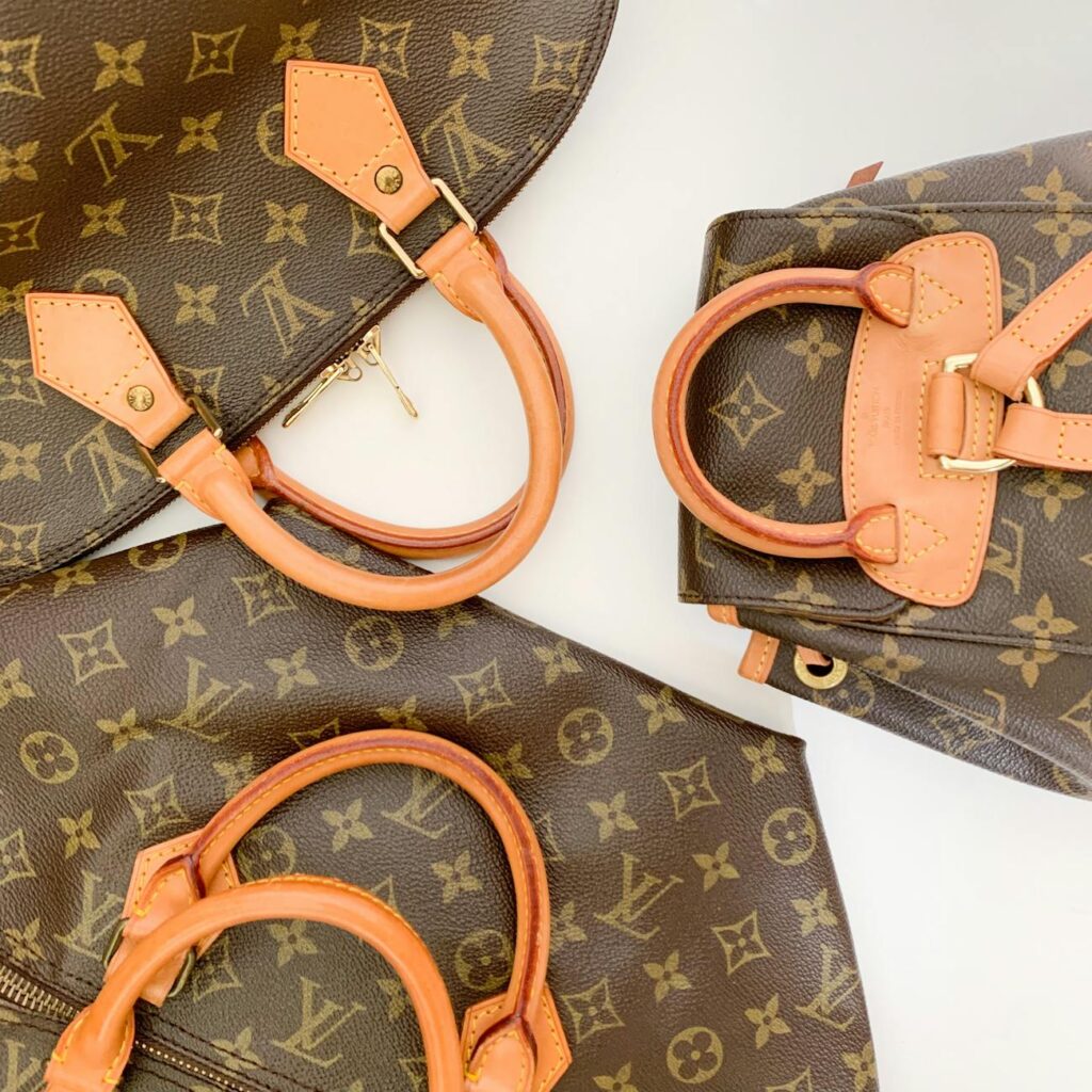 pexels photo 4276653 4276653 High-end designer leather handbags with monogram pattern lay elegantly displayed.